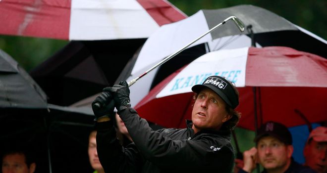 Phil Mickelson hits off the second tee on a soggy Sunday in Illinois