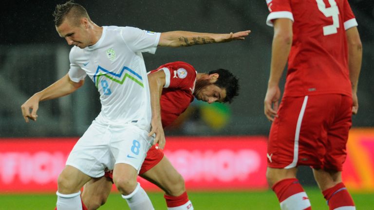 Jasmin Kurtic and Blerim Dzemaili tussle for the ball