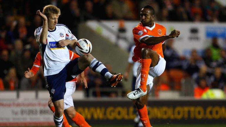 Blackpool's Ricardo Fuller is challenged by Tim Ream of Bolton