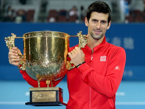 Novak Djokovic celebrates with the trophy