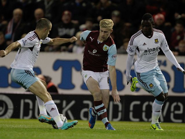 Joe Cole wins the ball from Ben Mee