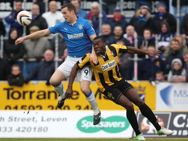 Jon Daly holds off Joe Mbu.