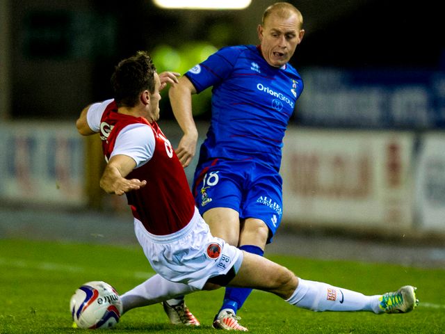 Keith Watson makes a challenge on Carl Tremarco