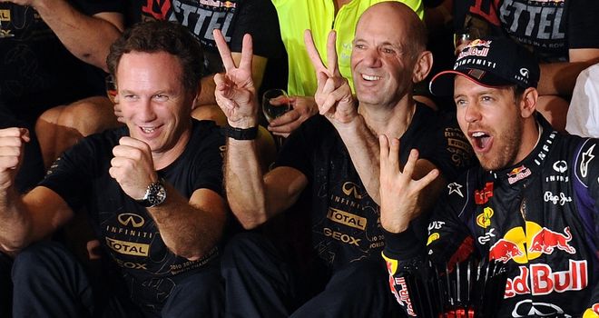 Adrian Newey (middle) celebrates with team principal Christian Horner (left) and Vettel (right)