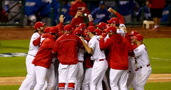 The St. Louis Cardinals celebrate after defeating the Los Angeles Dodgers 9-0 to make the World Series