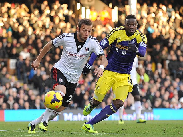Elsad Zverotic and Roland Lamah battle for the ball