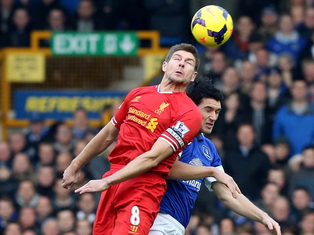 Steven Gerrard wins a header against Gareth Barry