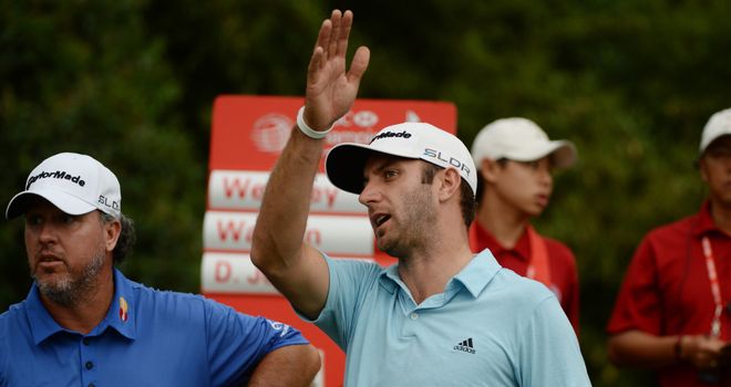 Dustin Johnson reacts to his tee-shot at 18 that found water