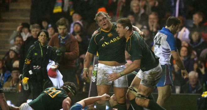 Coenie Oosthuizen, centre, celebrates his try at Murrayfield
