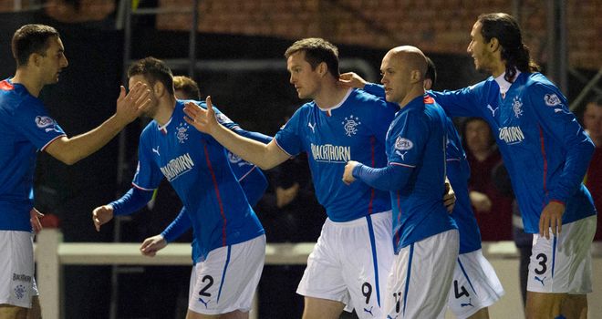 Jon Daly: Gets congratulations from his Rangers team-mates after opening scoring at Arbroath