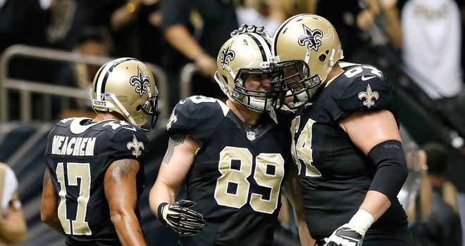 Josh Hill of the New Orleans Saints celebrates his touchdown with team-mates Robert Meachem and Zach Strief