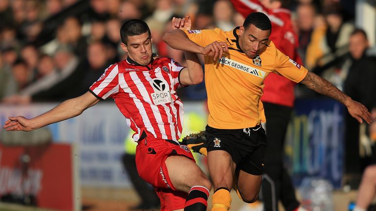 Sheffield United midfielder Conor Coady (l) tackles Cambridge's Nathan Arnold