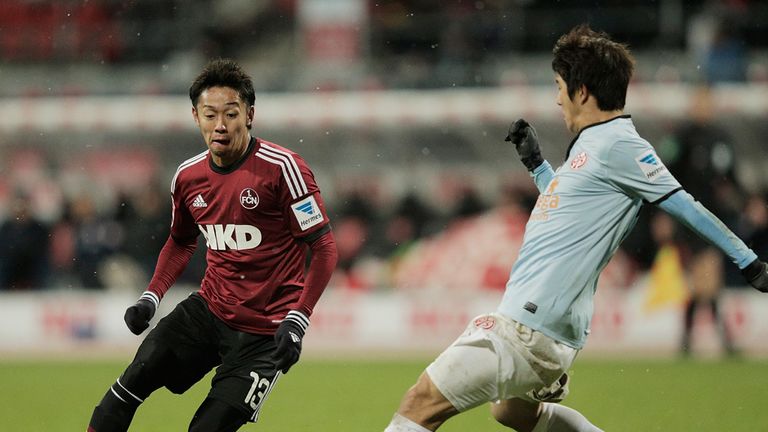 Hiroshi Kiyotake and Joo Ho Park battle for the ball
