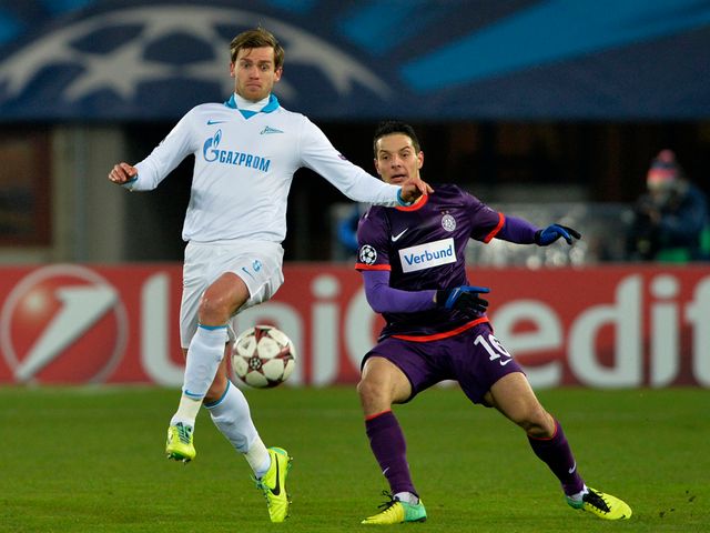 Nicolas Lombaerts knocks the ball away from Philipp Hosiner