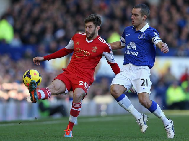 Adam Lallana is put under pressure by Leon Osman