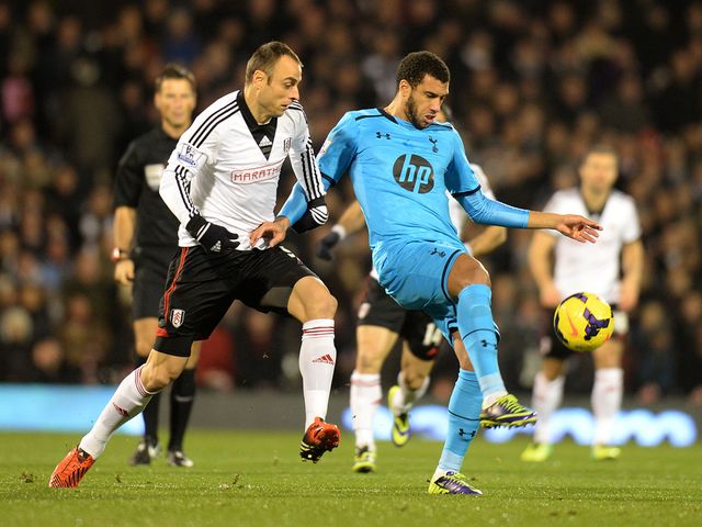 Dimitar Berbatov tackles Tottenham's Etienne Capoue