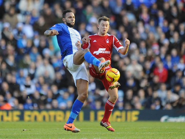 Kyle Bartley and Simon Cox battle for a bouncing ball