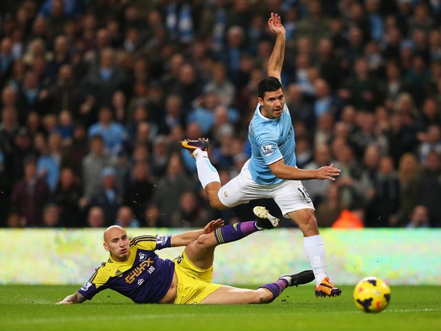 Shelvey tries to halt Aguero.