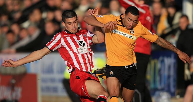 Sheffield United midfielder Conor Coady (l) tackles Cambridge's Nathan Arnold