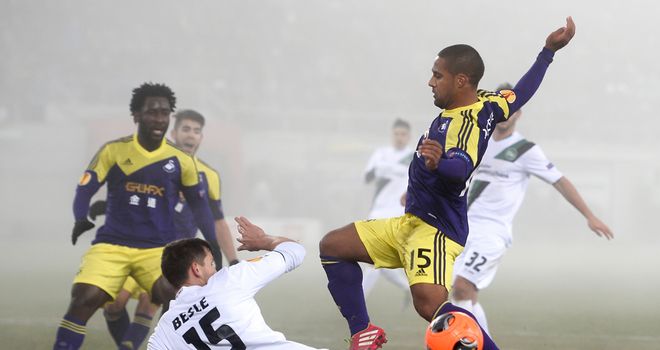 Swansea winger Wayne Routledge is challenged by Stephane Besle
