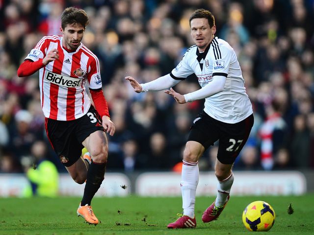 Fabio Borini of Sunderland and Sascha Riether do battle