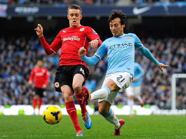 David Silva knocks the ball away from Craig Noone