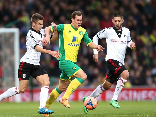 Norwich City's Steven Whittaker takes on Fulham players