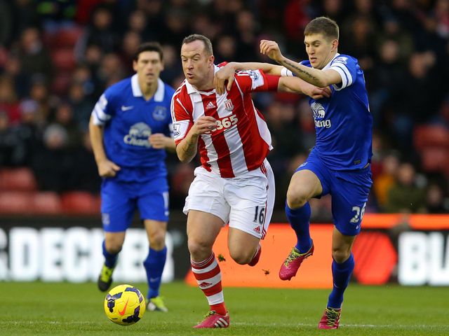 Charlie Adam tries to escape from John Stones