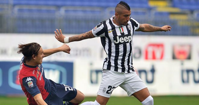 Juventus midfielder Arturo Vidal is tackled