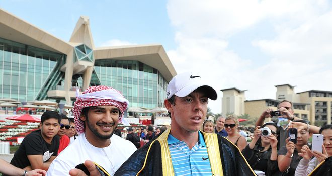 Rory McIlroy is presented with a traditional Emirati Bisht