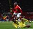 Hugo Lloris challenges Ashley Young at Old Trafford