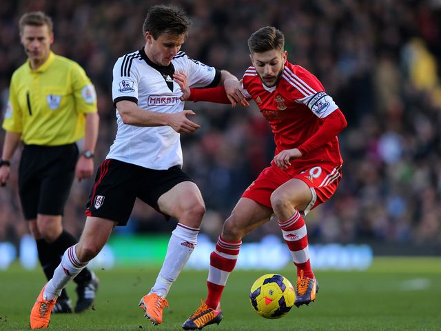 William Kvist (left) in action against Adam Lallana