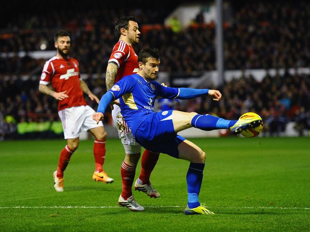 David Nugent knocks the ball away from Andy Reid