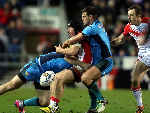 Jonny Lomax is tackled by Joe Arundel and Gareth Ellis