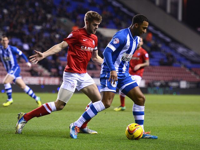 Nicky Maynard of Wigan in action with Martin Cranie of Barnsley