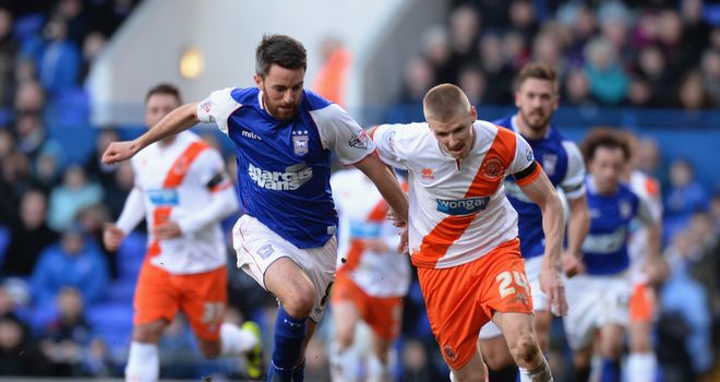 Cole Skuse of Ipswich Town tackles Andy Keogh of Blackpool.