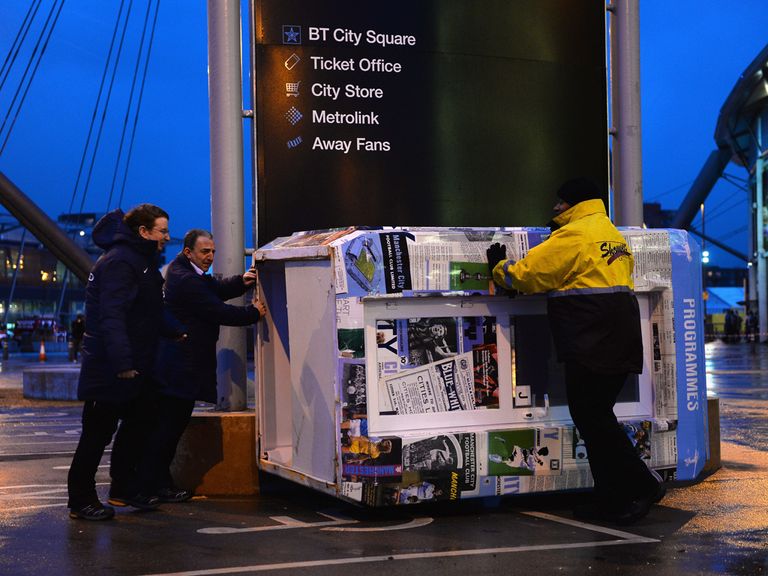 A programme booth blows over outside the Etihad Stadium
