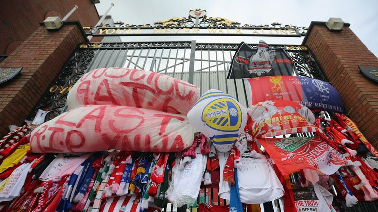 Tributes to the victims of the Hillsborough Disaster adorn the Hillsborough memorial and the Bill Shankly gates at Anfield stadium