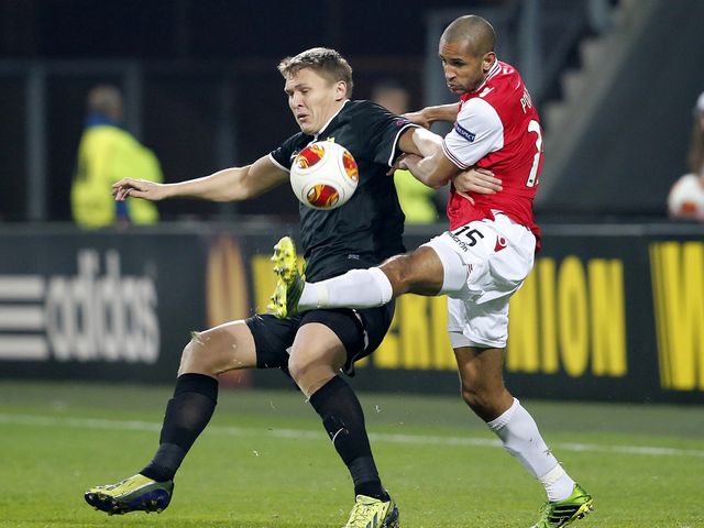 Simon Poulsen (R) fights for the ball with Aleksandr Bukharov