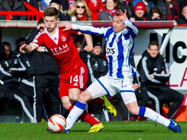 Cammy Smith is tackled by Barry Nicholson