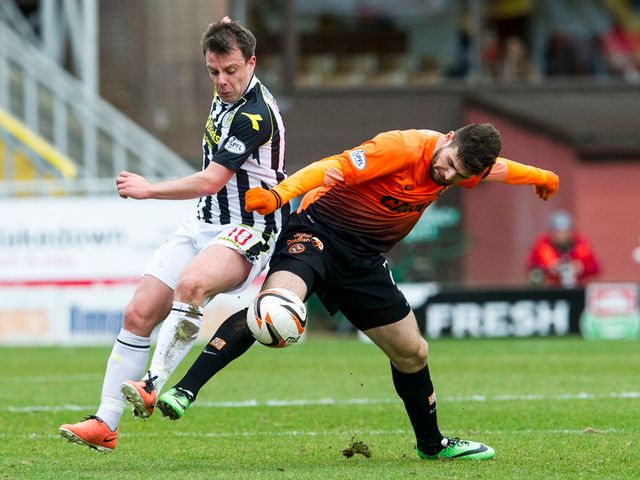 Paul McGowan and Nadir Ciftci battle for the ball