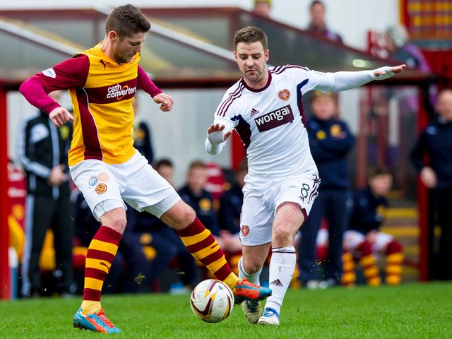 Iain Vigurs is closed down by Scott Robinson
