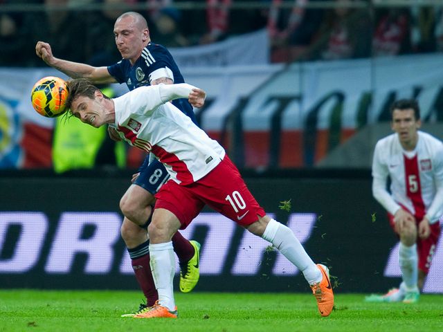 Ludovic Obraniak gets to the ball ahead of Scott Brown
