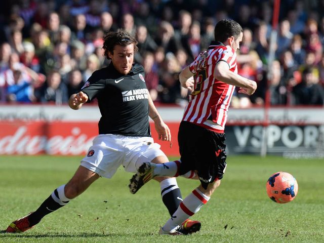 Stefan Scougall is tackled by Lawrie Wilson