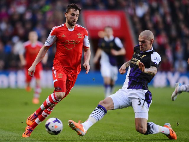 Jay Rodriguez is tackled by Martin Skrtel