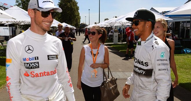 Button greets former team-mate Lewis Hamilton in the Melbourne paddock