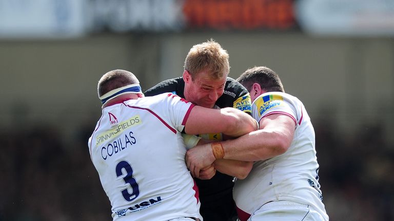 Vadim Cobilas and Eifion Lewis Roberts wrap up Exeter's Damian Welch