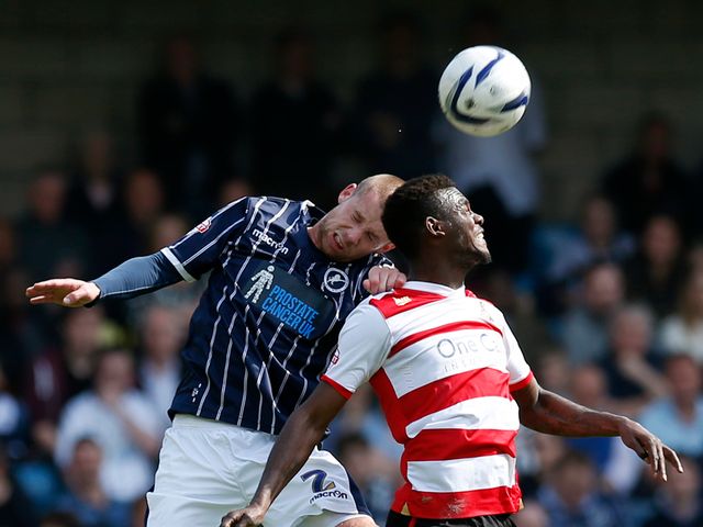 Millwall's Alan Dunne (left) leaps for a header