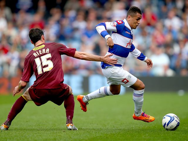 Ravel Morrison of QPR is challenged by Albert Riera of Watford