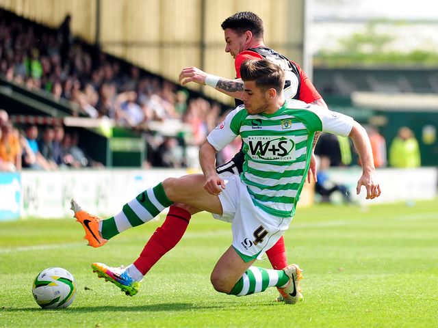Joe Edwards of Yeovil Town battles for the ball with Adam Hammill of Huddersfield